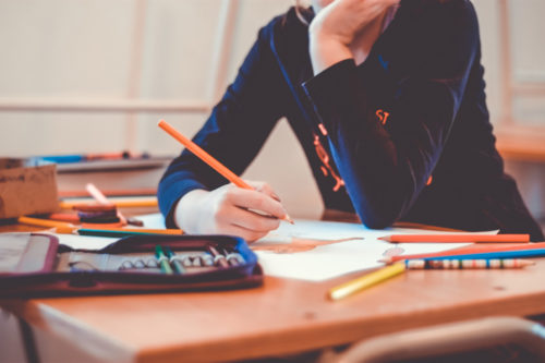 散らかった机で勉強している様子